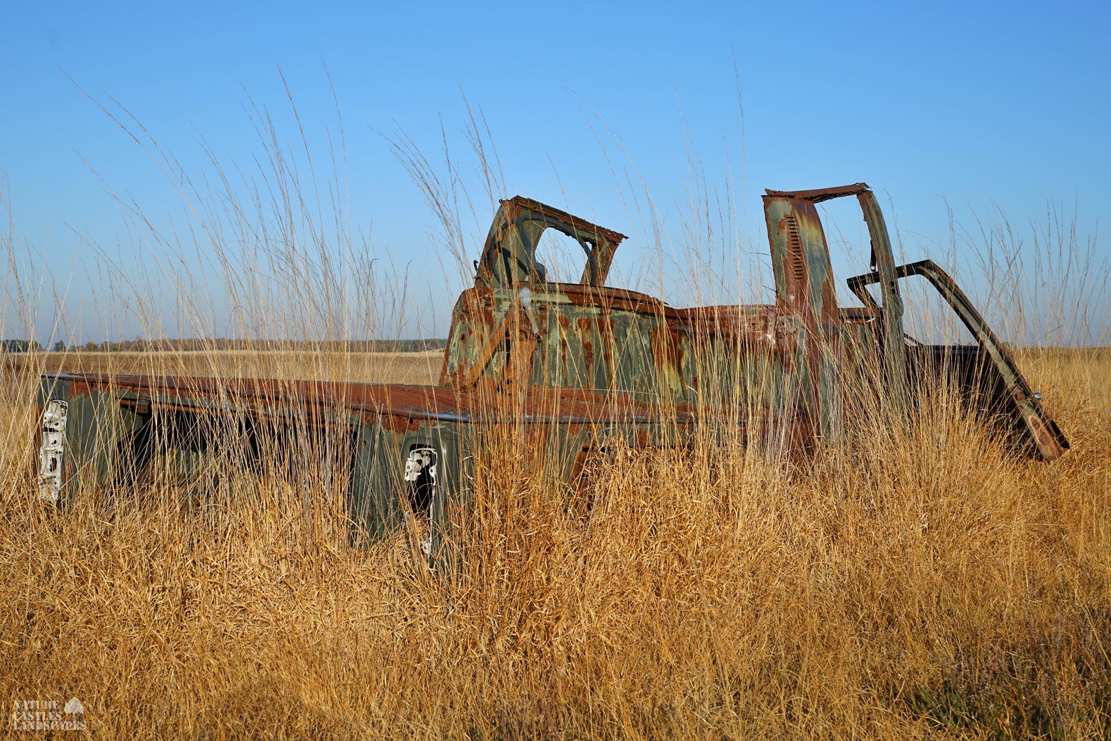 rusty car in the heath
