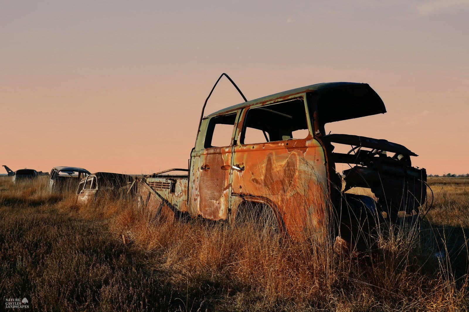 rusty car wreck caravan at sunset