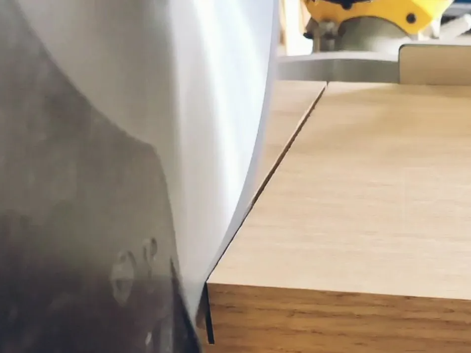 Miter saw cutting a thick oak board