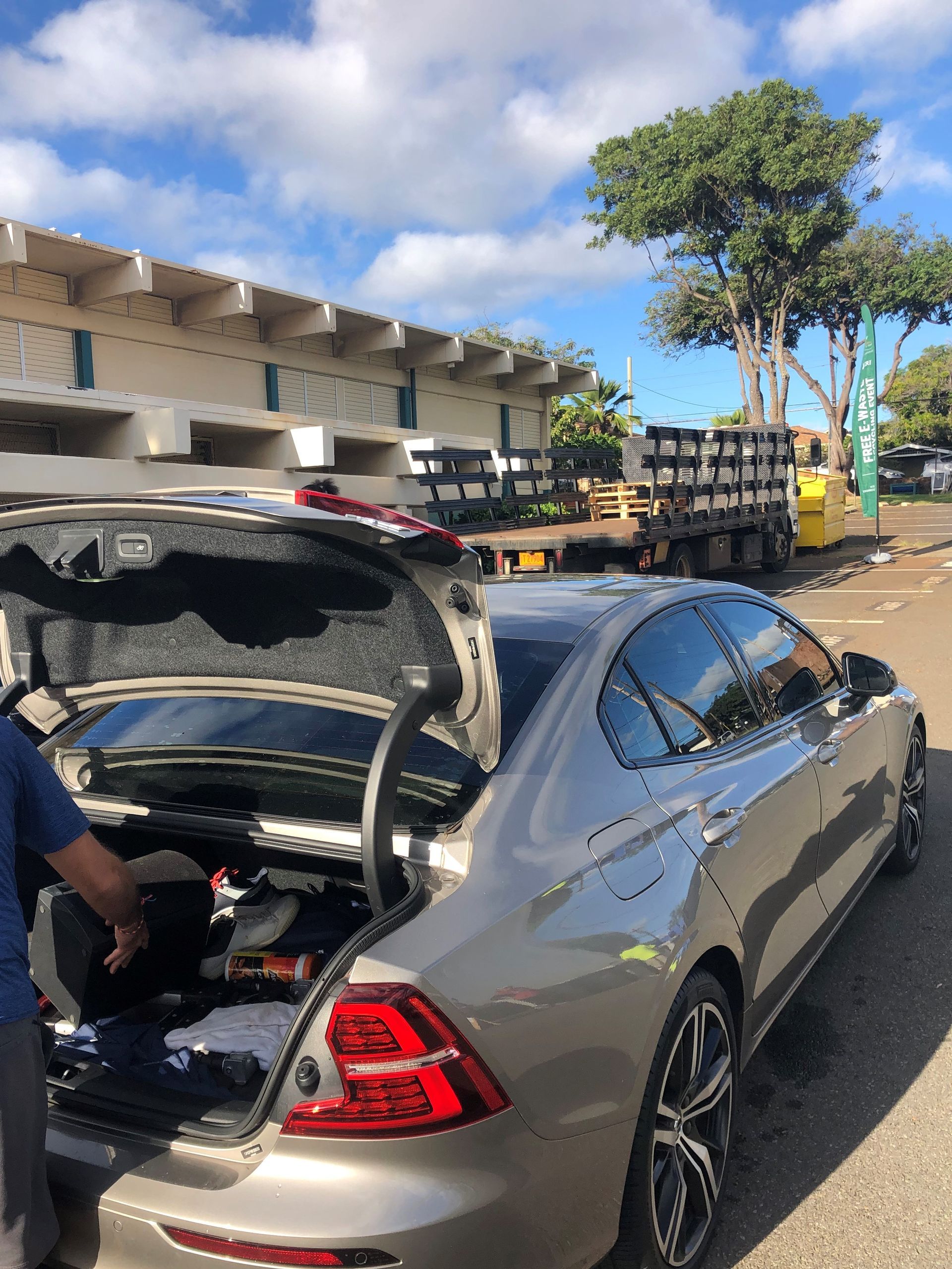 Person unloading electronics from their car to drop off