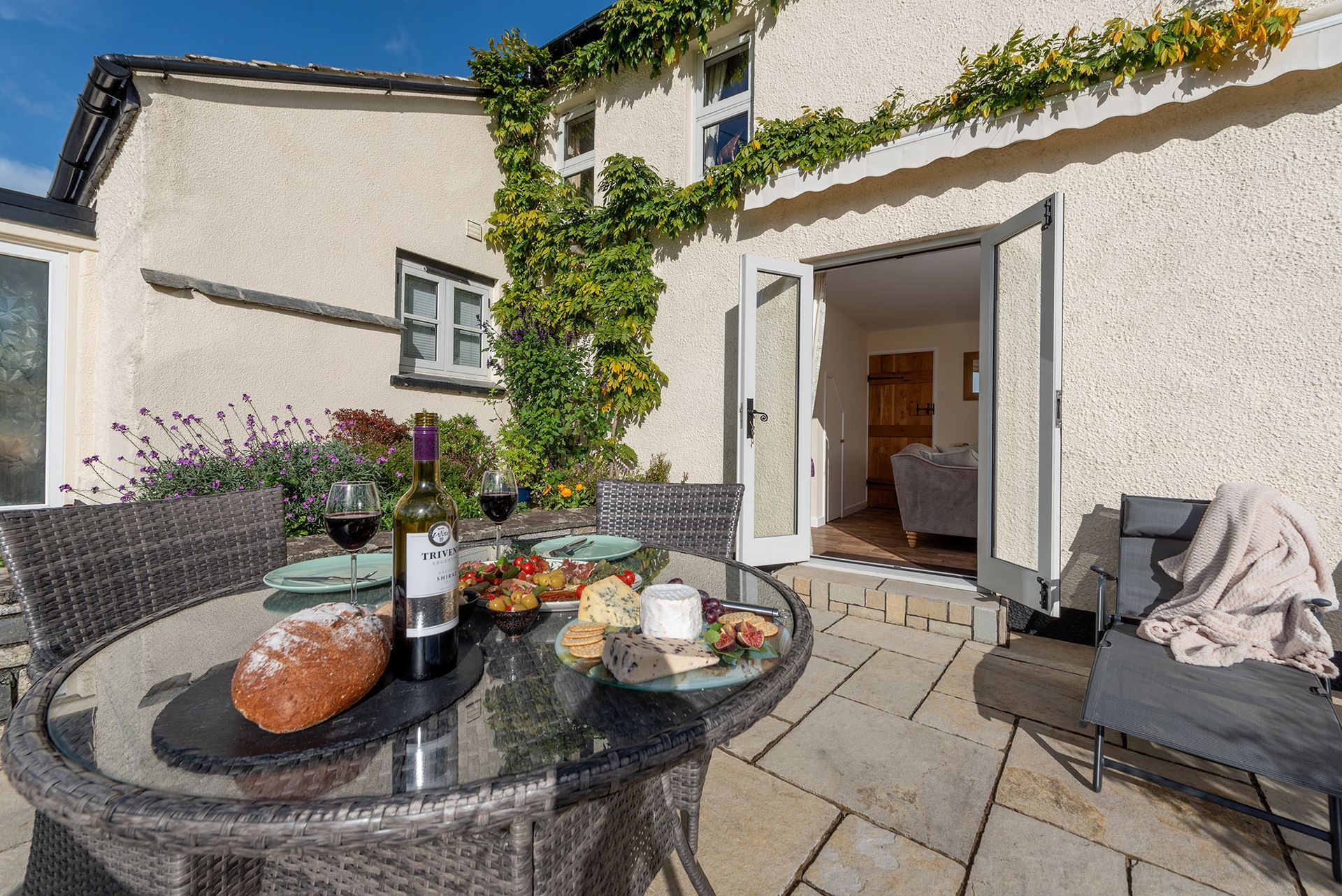 The Cottage holiday cottage patio with sunloungers and dining, Higher Kellacott 