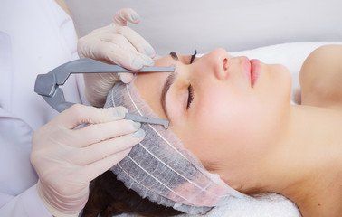 Beauty client getting eyebrows measured