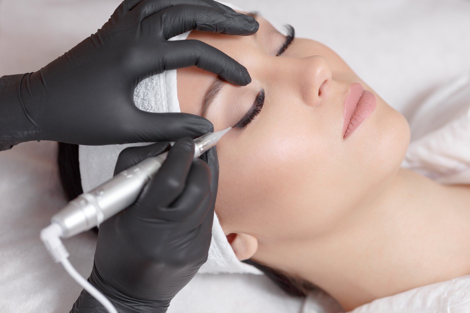 Woman getting permanent makeup removal