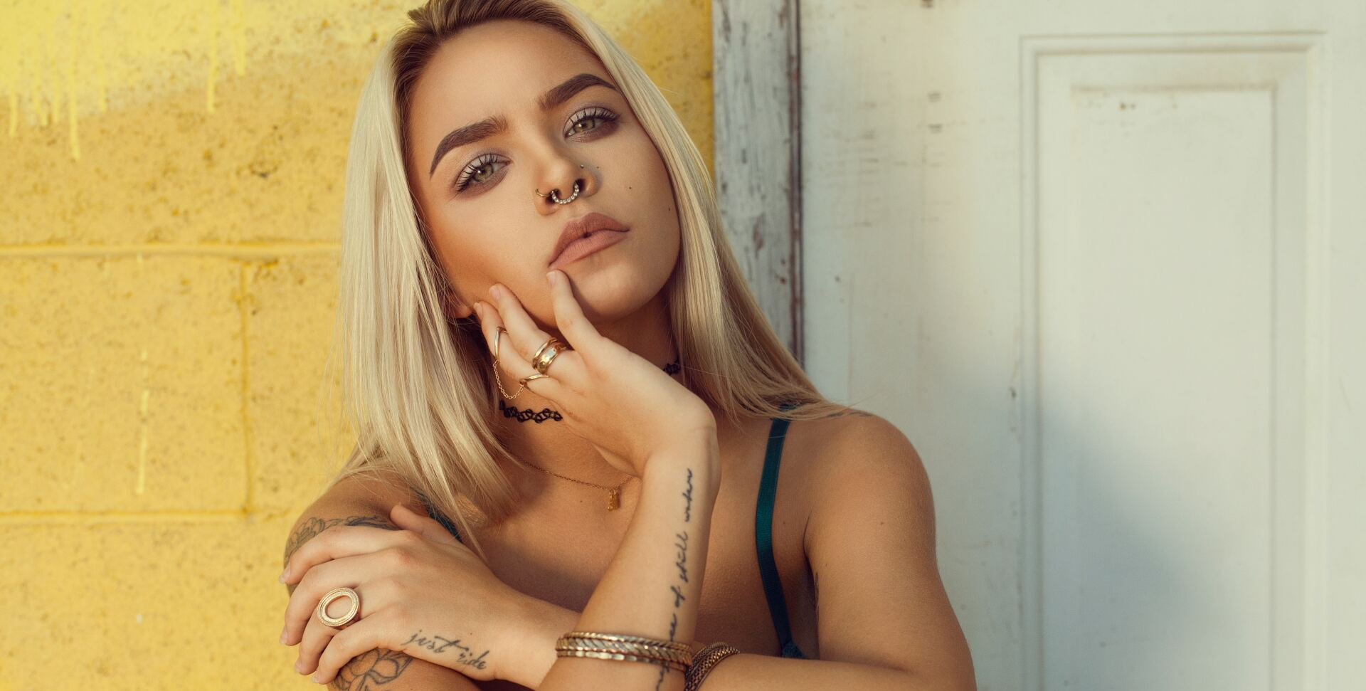 Woman with tattoos and piercings.