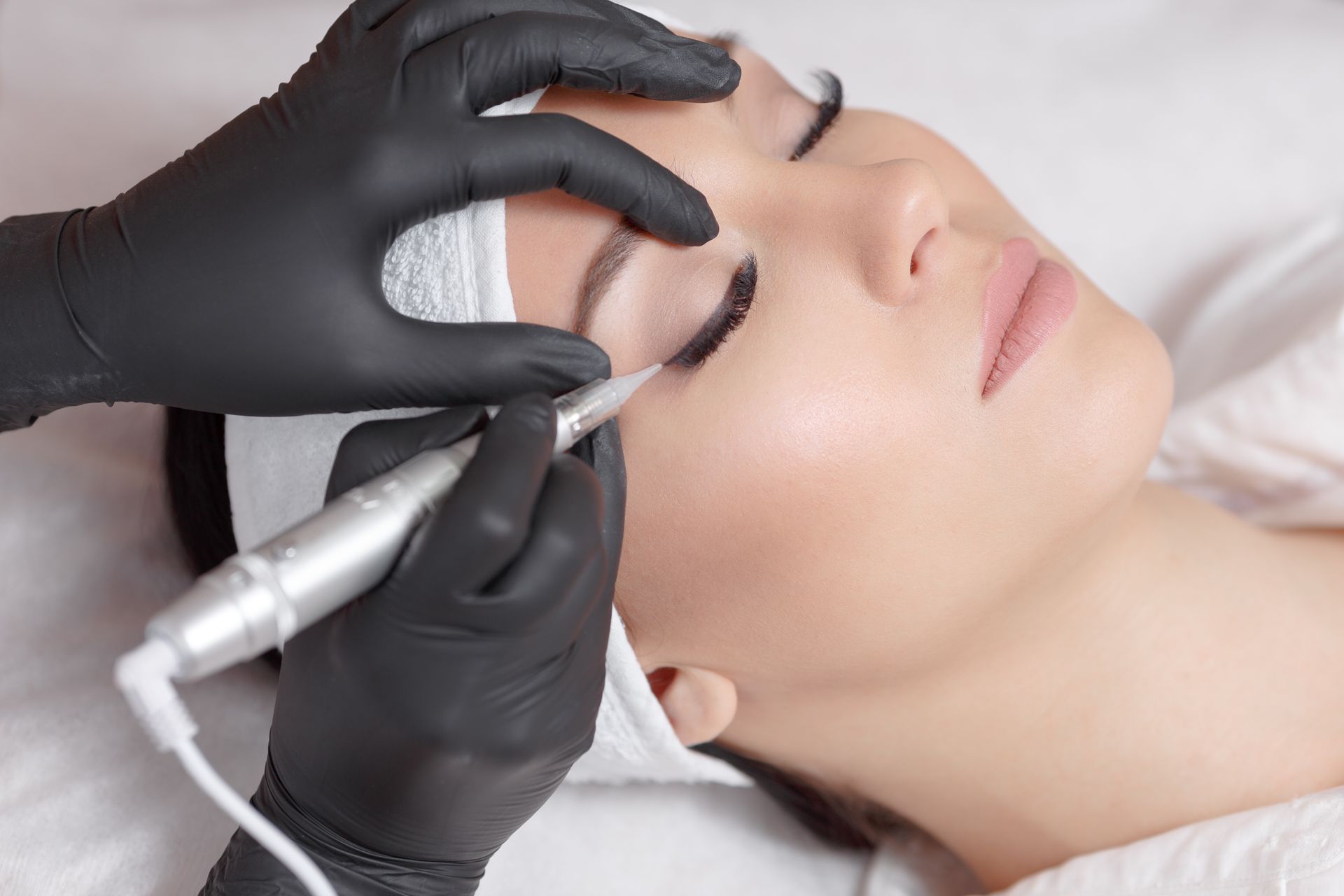 Woman getting brows tattooed