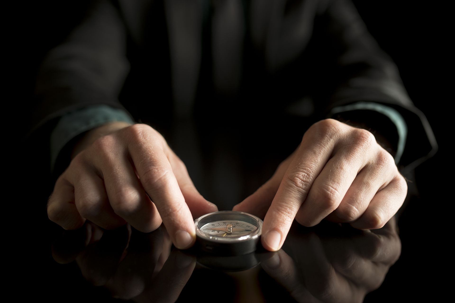 A person looks at a compass