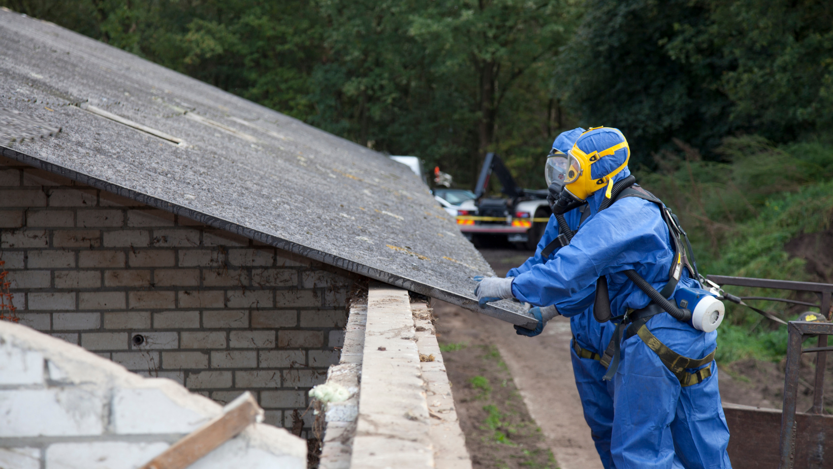 men removing asbestos off a roof
