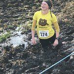 A runner in a trail race trudging through mud